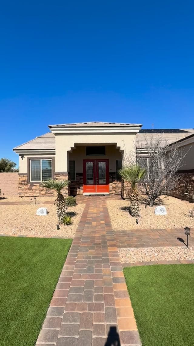 Beautiful Las Vegas home with red door and brick walkway